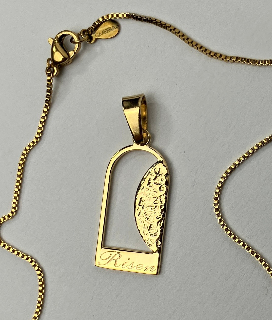 Empty Tomb pendant, stainless steel, gold color, size 12mm x 23mm H, extended base, inscribed "Risen" font Palace script, textured stone. (CHAIN SOLD SEPARATELY)