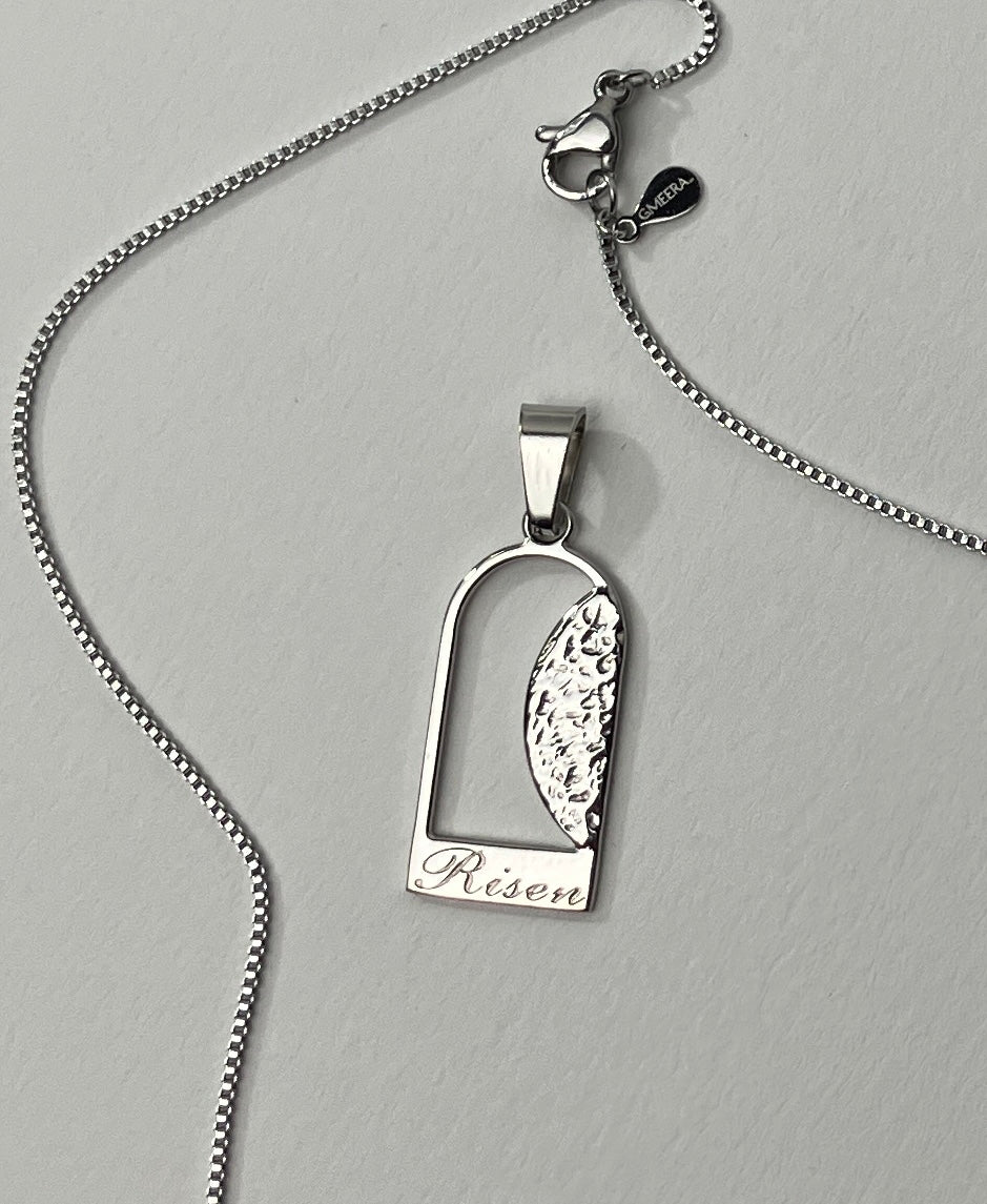 Empty Tomb pendant, stainless steel, silver color, size 12mm x 23mm H, extended base, inscribed "Risen" font Palace script, textured stone. (CHAIN SOLD SEPARATELY)