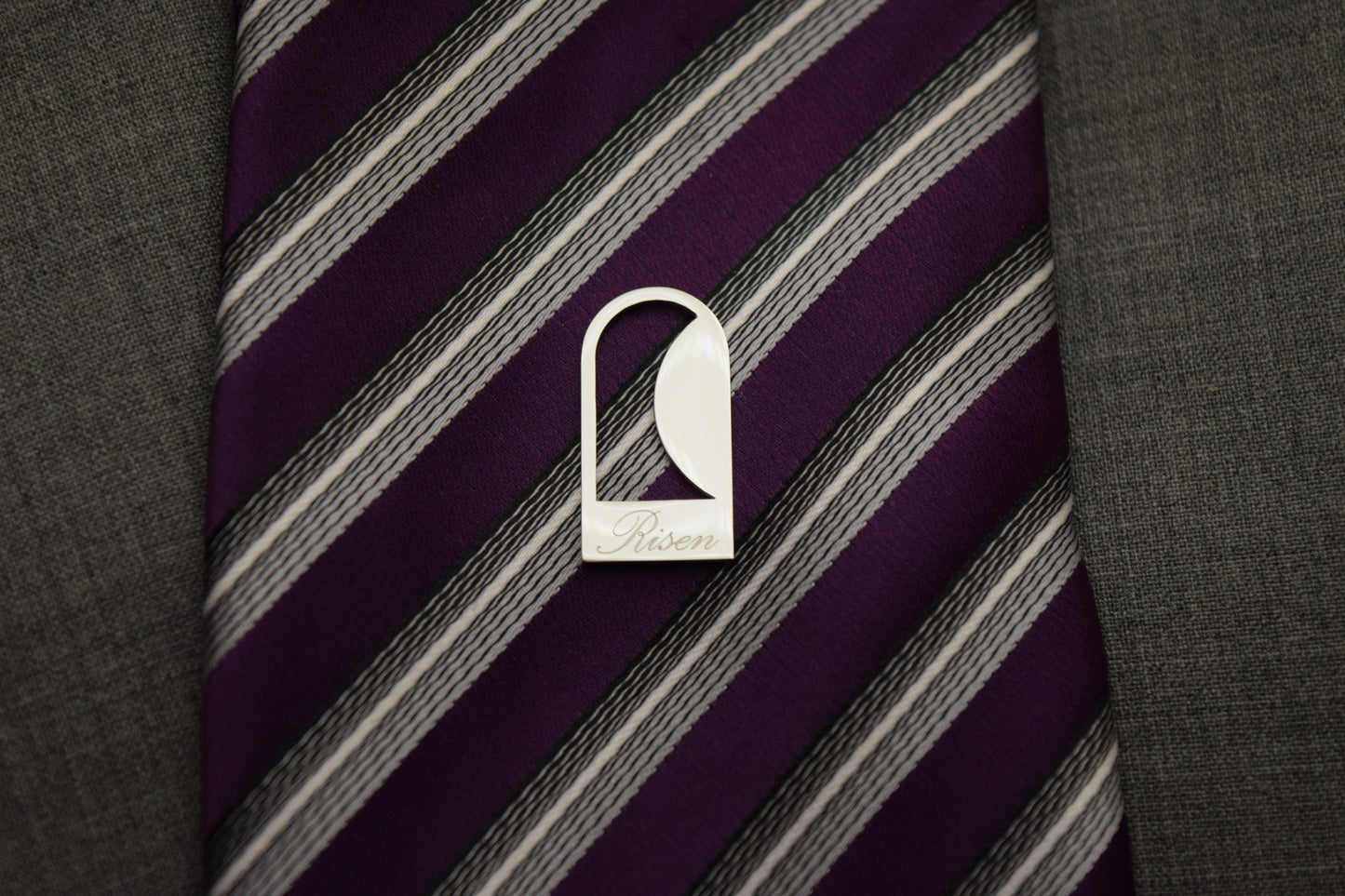 Empty Tomb lapel/tie pin, stainless steel, silver color, size 12mm x 23mm H, extended base, inscribed "Risen" font Palace script, smooth stone