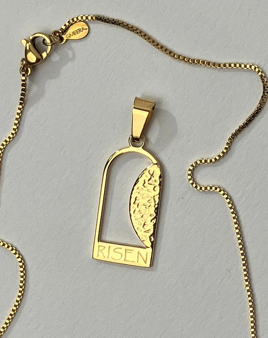 Empty Tomb pendant, stainless steel, gold color, size 12mm x 23mm H, extended base, inscribed "RISEN" font Papyrus, textured stone. (CHAIN SOLD SEPARATELY.)