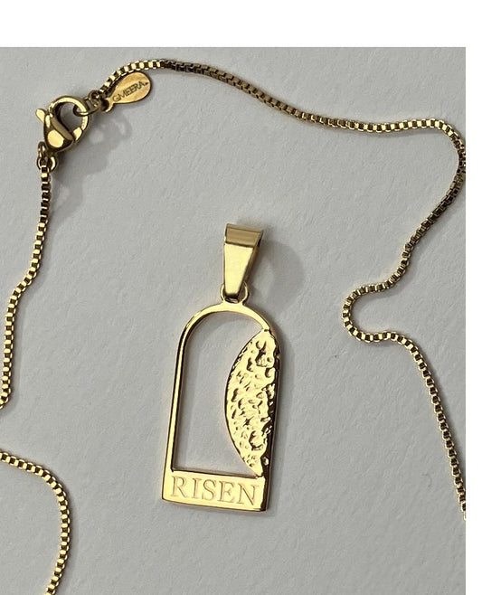 Empty Tomb pendant, stainless steel, gold color, size 12mm x 23mm H, extended base, inscribed "RISEN" font Times New Roman, textured stone. (CHAIN SOLD SEPARATELY.)